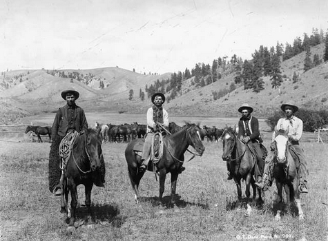 Four cowboys pose for a photo in Montana.