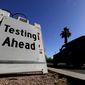In this May 23, 2020, file photo, a vehicle arrives at COVID-19 testing site at Steele Indian School Park, in Phoenix. Coronavirus cases are rising in nearly half the U.S. states, as states are rolling back lockdowns. (AP Photo/Matt York, File)