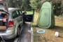 Associated Press editor Michael Warren's car sits next to a fold-out toilet seat and a pop-up changing tent at a rest ...