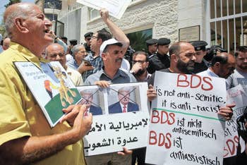 Protesters stage a demonstration outside Germany's Representative Office in Ramallah in the West Bank on May 22, 2019.