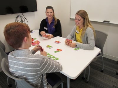 Students with clients playing a game