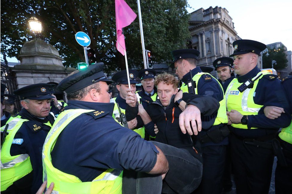 Police remove a protester during an Extinction Rebellion demonstration in Dublin