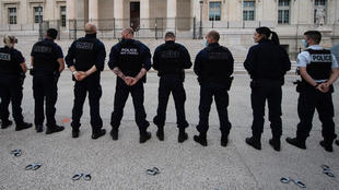French police officers stand back in front of Marseille's High Court as they threw their handcuffs on the ground during a gathering in Marseille, southern France on June 11, 2020, to protest against measures to counter police violence.