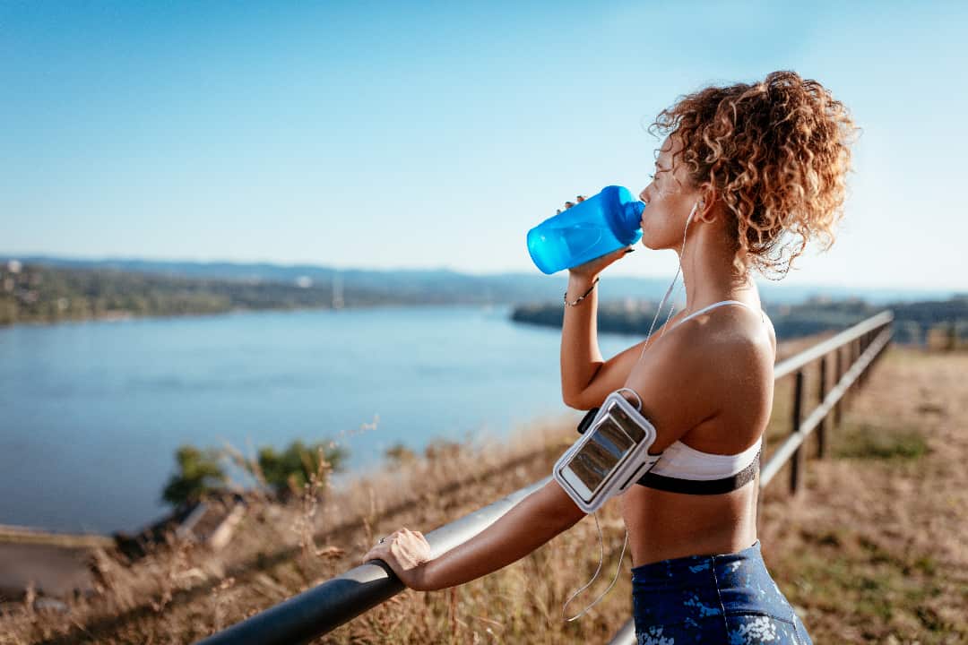 Woman Drinking Water with Magnesium During Exercise
