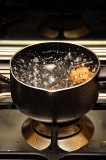 water boiling in a cooking pot on a stove