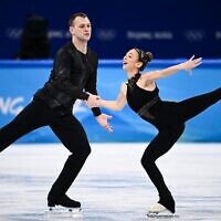 Israel's Hailey Kops and Evgeni Krasnopolski compete in the pair skating short program of the figure skating event during the Beijing 2022 Winter Olympic Games at the Capital Indoor Stadium in Beijing on February 18, 2022. (Anne-Christine POUJOULAT / AFP)