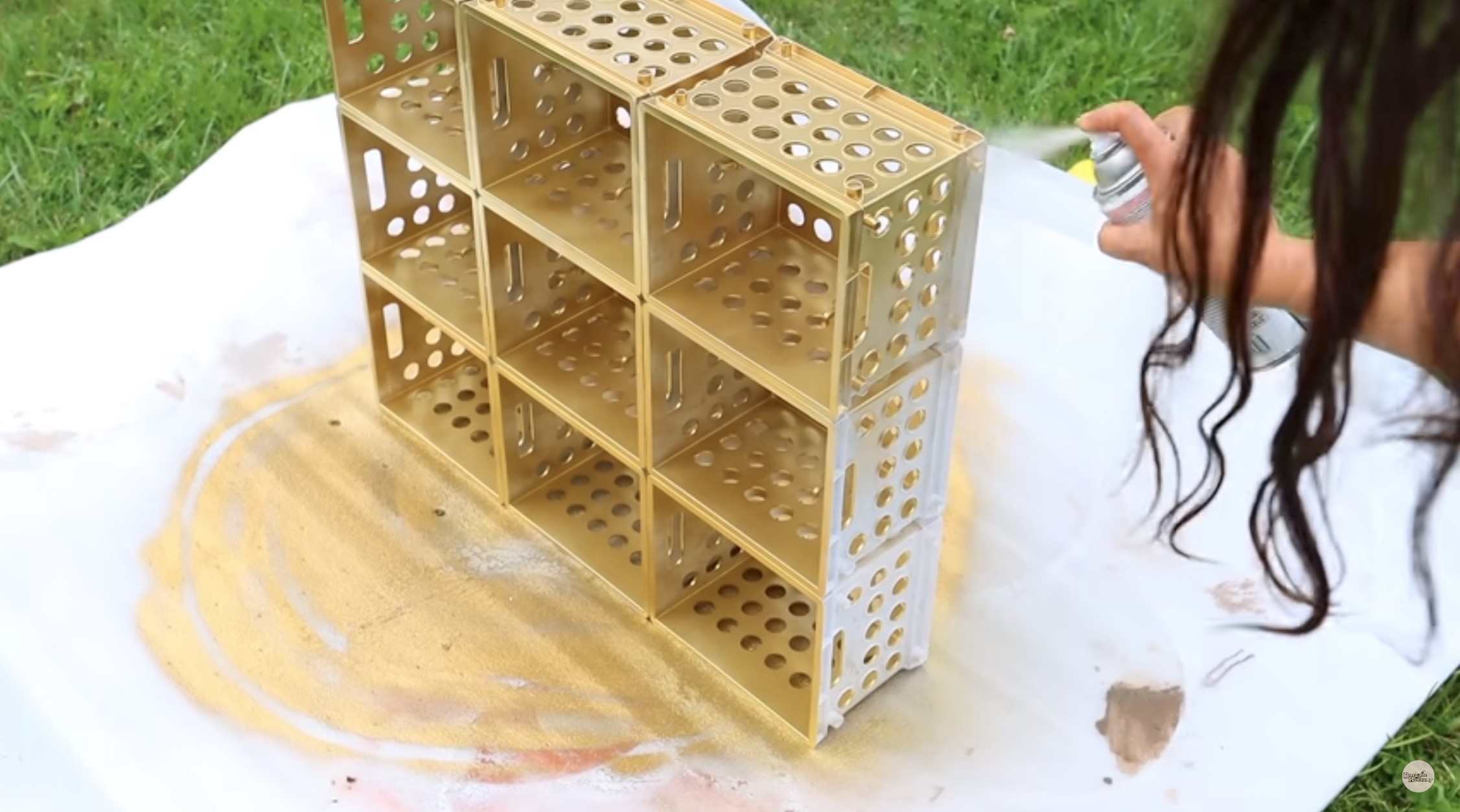 Bethany uses Rustoleum metallic gold spray paint to finish off her storage containers