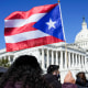 A woman waves the flag of Puerto Rico